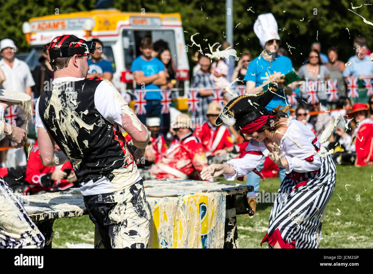 Team of people dressed as pirates throwing and getting hit by custard pies during the world custard Pie championships at Coxheath, Maidstone. Stock Photo