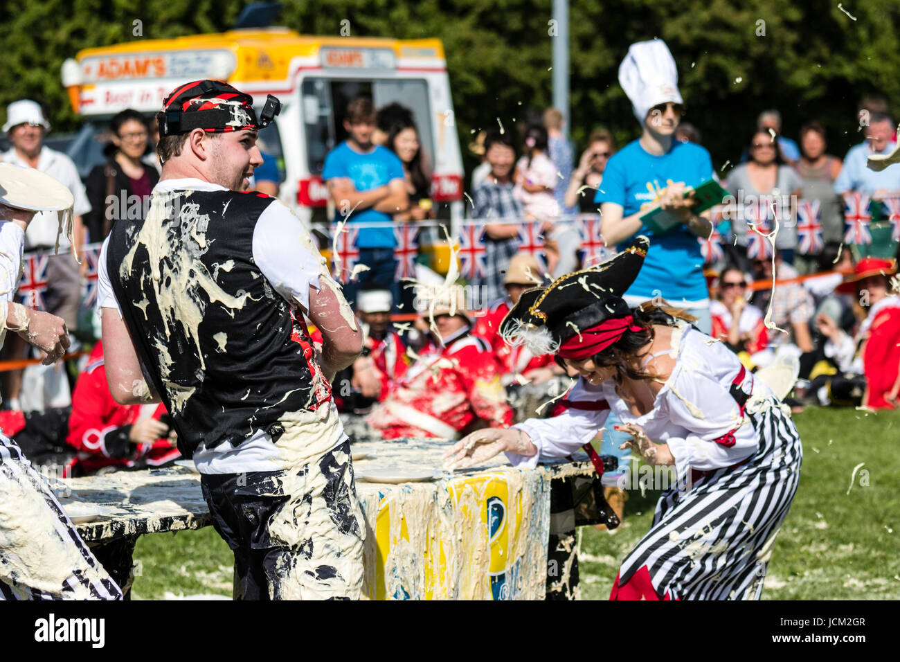 Team of people dressed as pirates throwing and getting hit by custard pies during the world custard Pie championships at Coxheath, Maidstone. Stock Photo