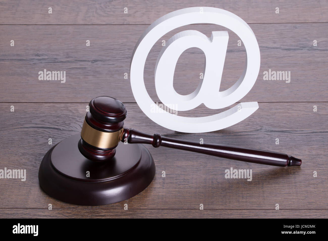 Judge gavel and at symbol representing online crime concept Stock Photo