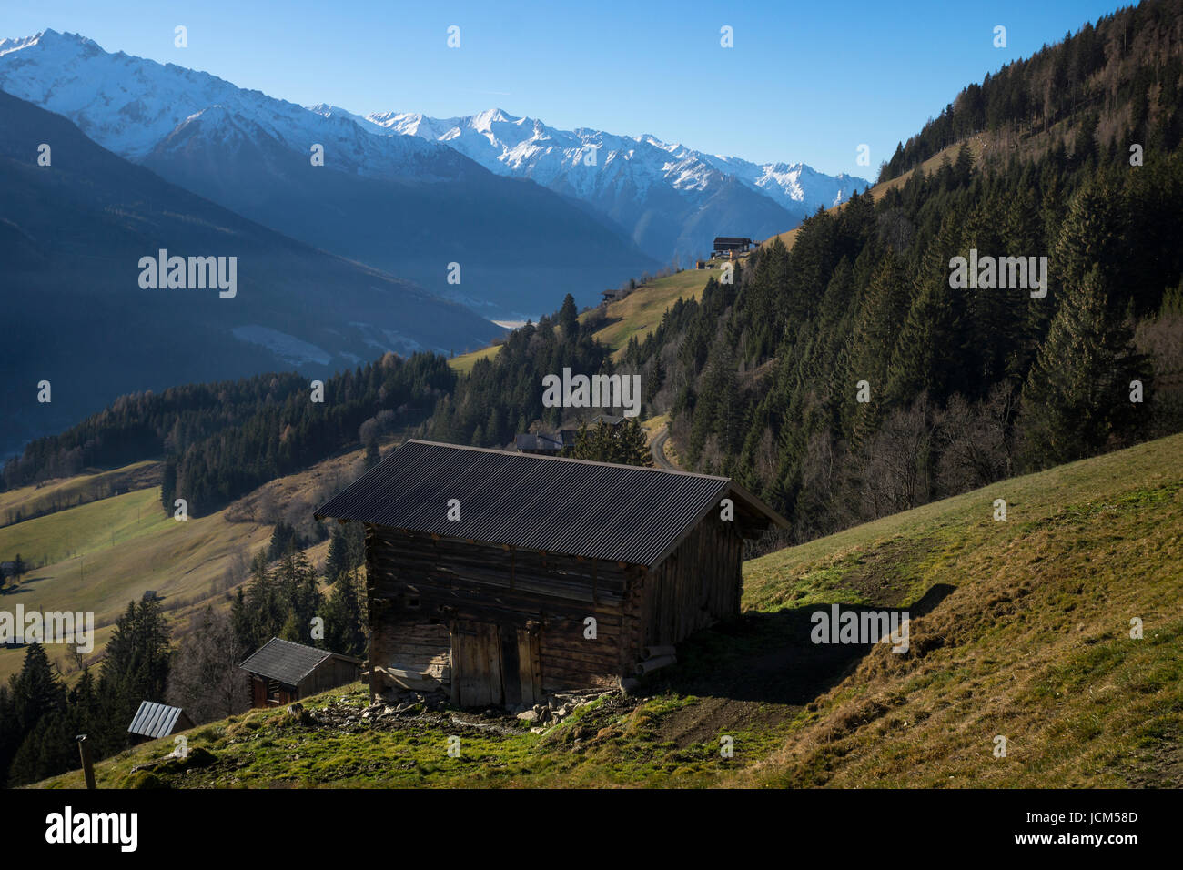 Hut on green gras with a view on the snowy mountains, Tirol Austria, Pass Thurn Stock Photo