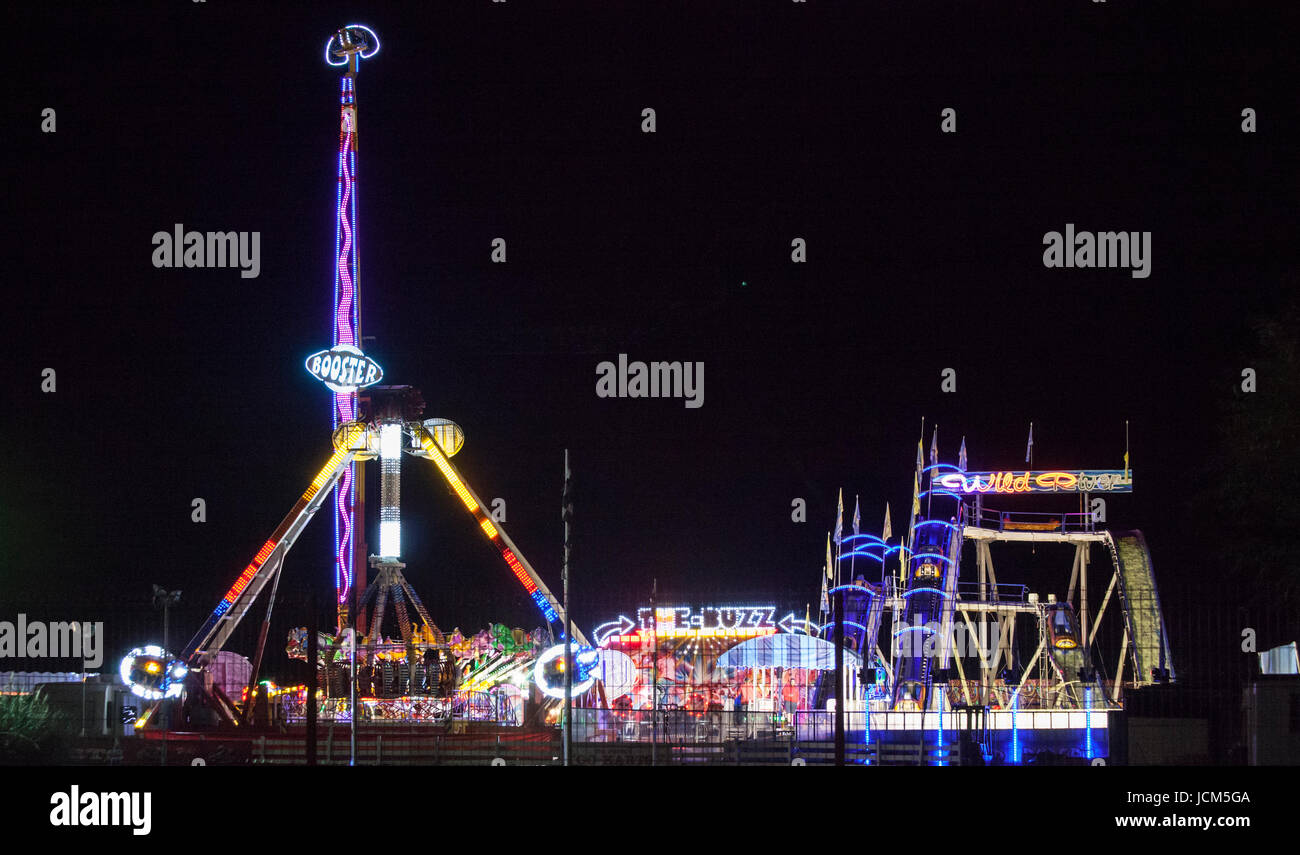 rides lit up at night at the fun fair Stock Photo