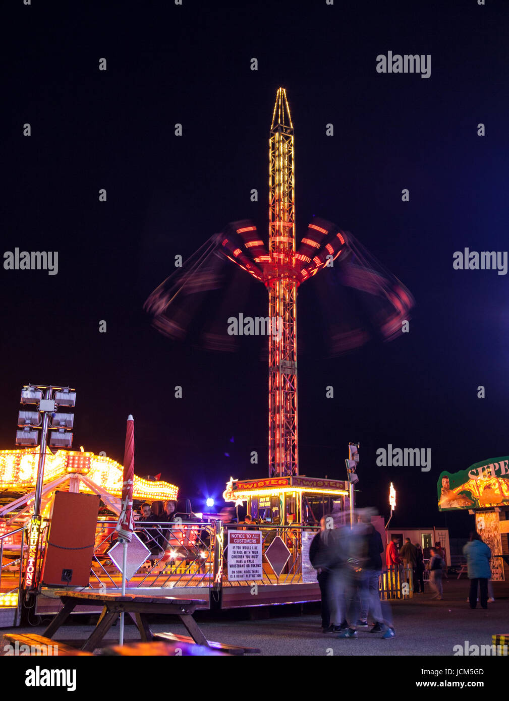 rides lit up at night at the fun fair Stock Photo