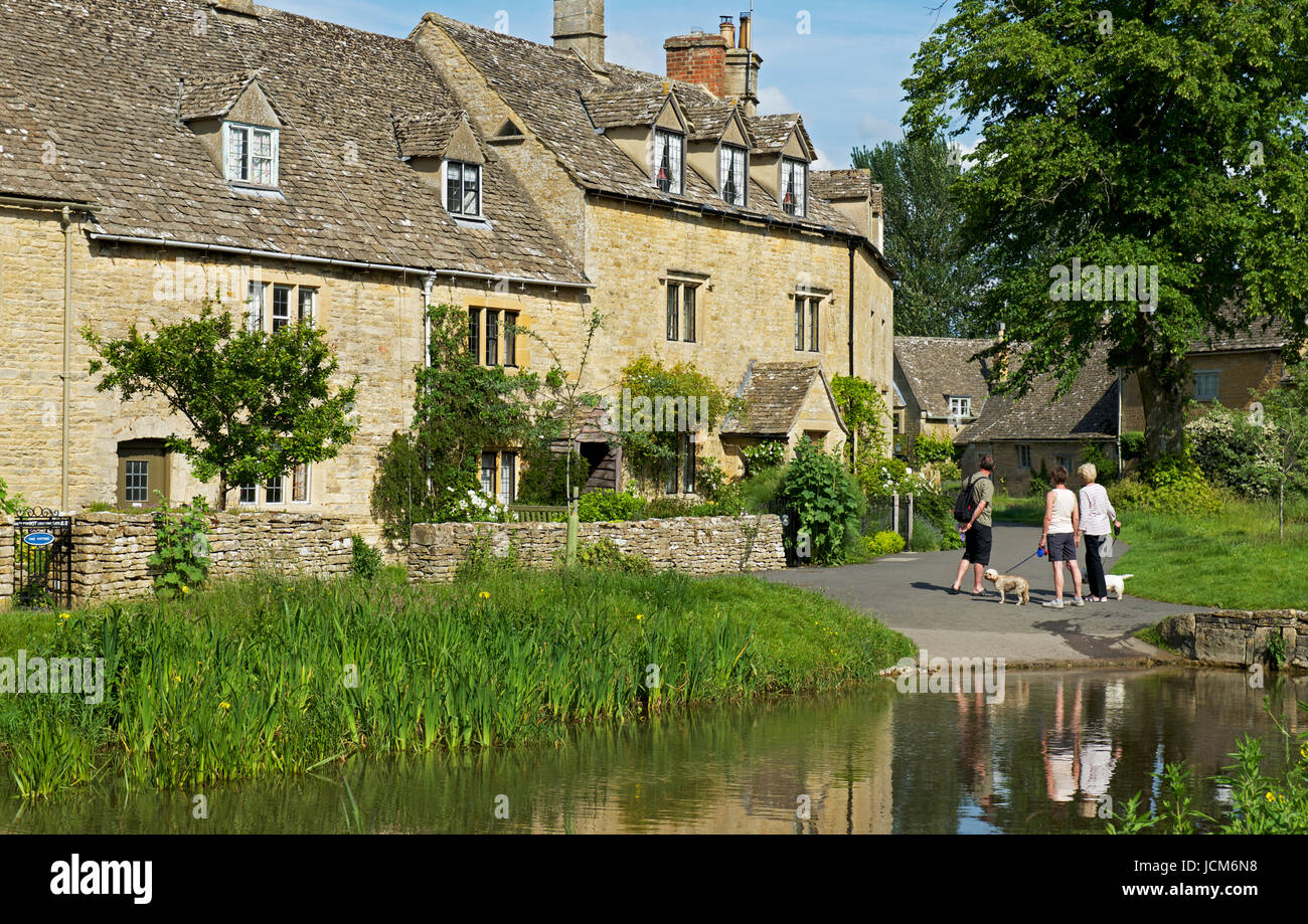 Walkers in the village of Lower Slaughter, Gloucester, England UK Stock Photo