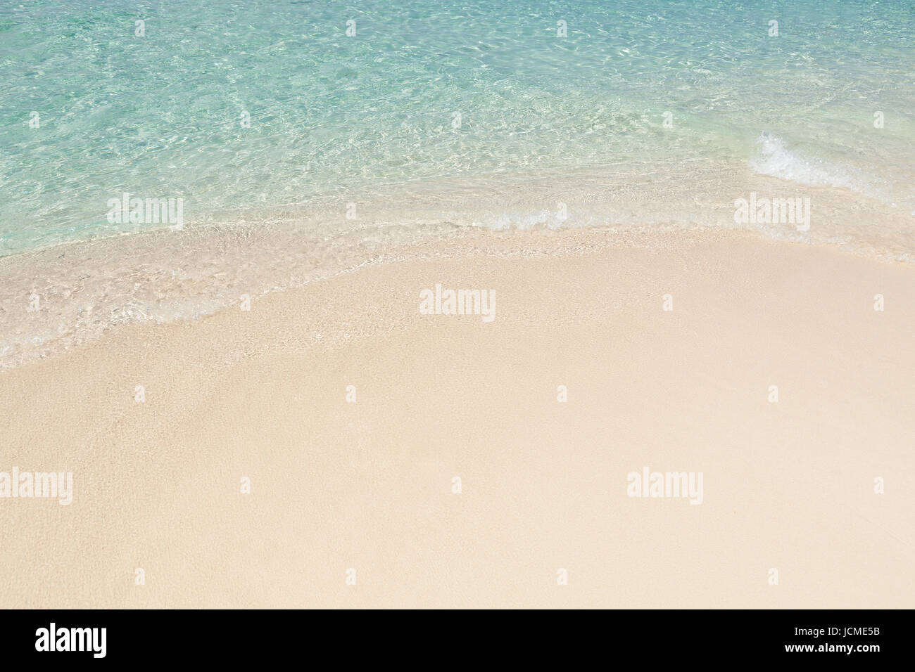 Sand Rushing Waves rushing on sand at tranquil beach Stock Photo - Alamy