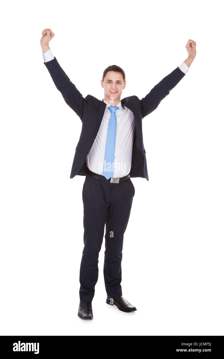 Full length portrait of successful businessman with arms raised ...