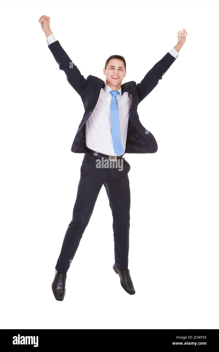 Full length portrait of successful businessman with arms raised ...