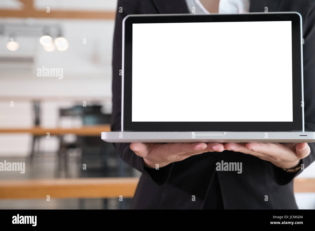 Young asian business woman smiling and showing blank laptop computer ...