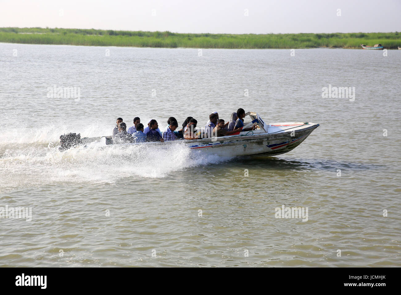 People cross the Padma River on speedboats on the Maowa-Kaorhakandi route without putting life jackets. Munshiganj, Bangladesh Stock Photo