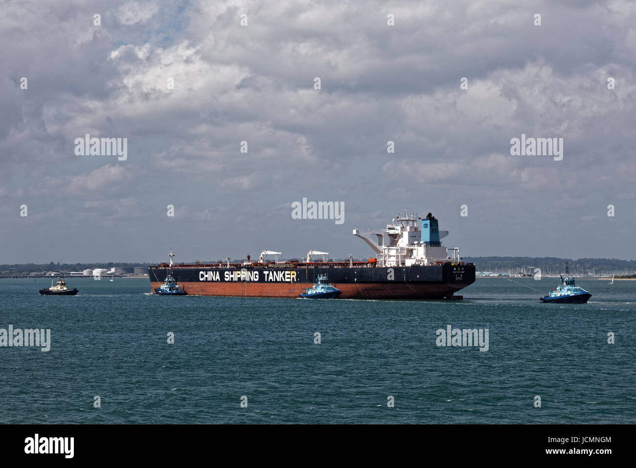 China Shipping Tanker Xin Yong Yang escorted through Southampton water to the Esso refinery by Solent Towage Fleet tugs Apec Phenix and Lomax Stock Photo