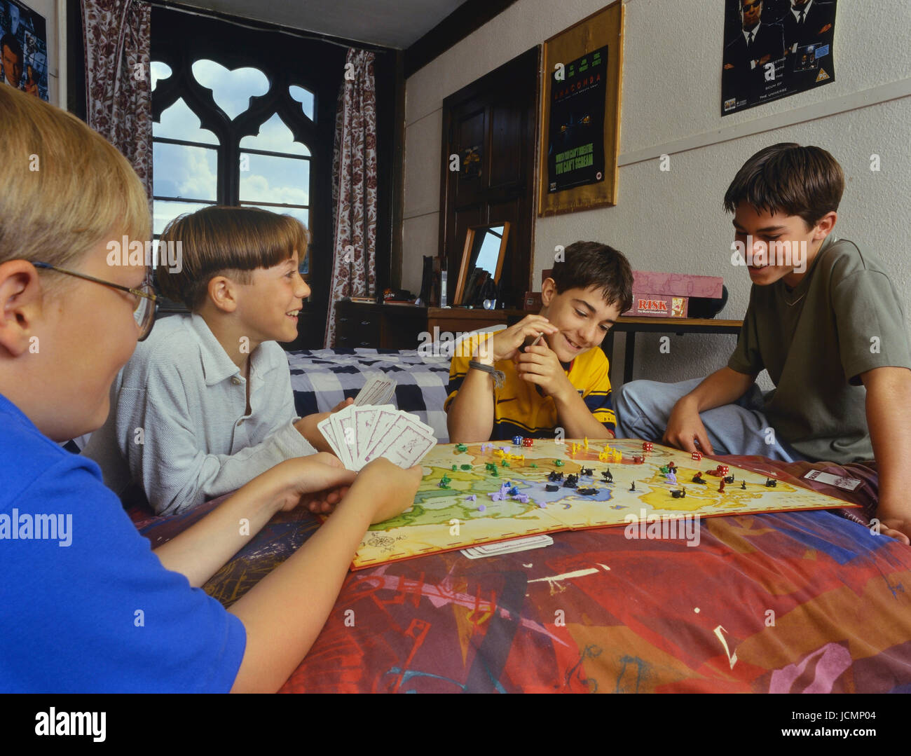 Boarding school boys playing the board game of Risk in their dormitory. England Stock Photo