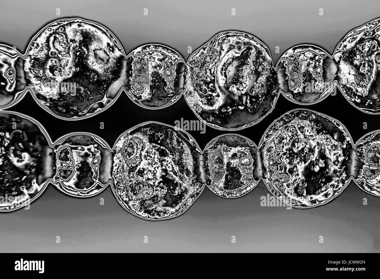 Necklace from black vesuvian Vesuvius and hematite. Macro shot Processed on grey background. Stock Photo