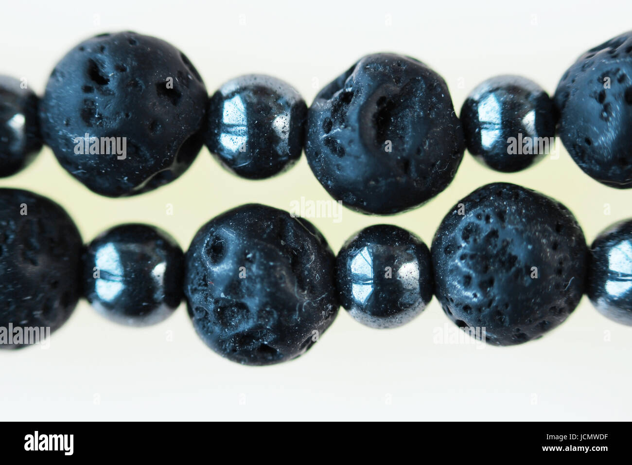 Necklace from black vesuvian Vesuvius and hematite. Macro shot on white background. Stock Photo