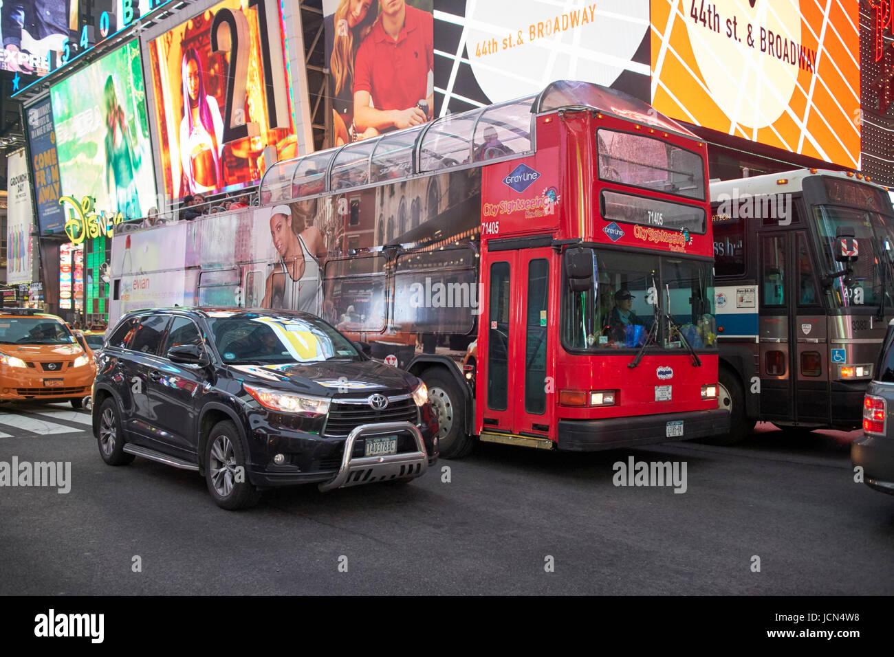 city sightseeing bus on a wet busy evening in Times Square New York