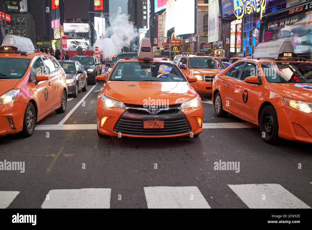 yellow cabs in the evening stopped at crosswalk in Times Square New York City USA Stock Photo