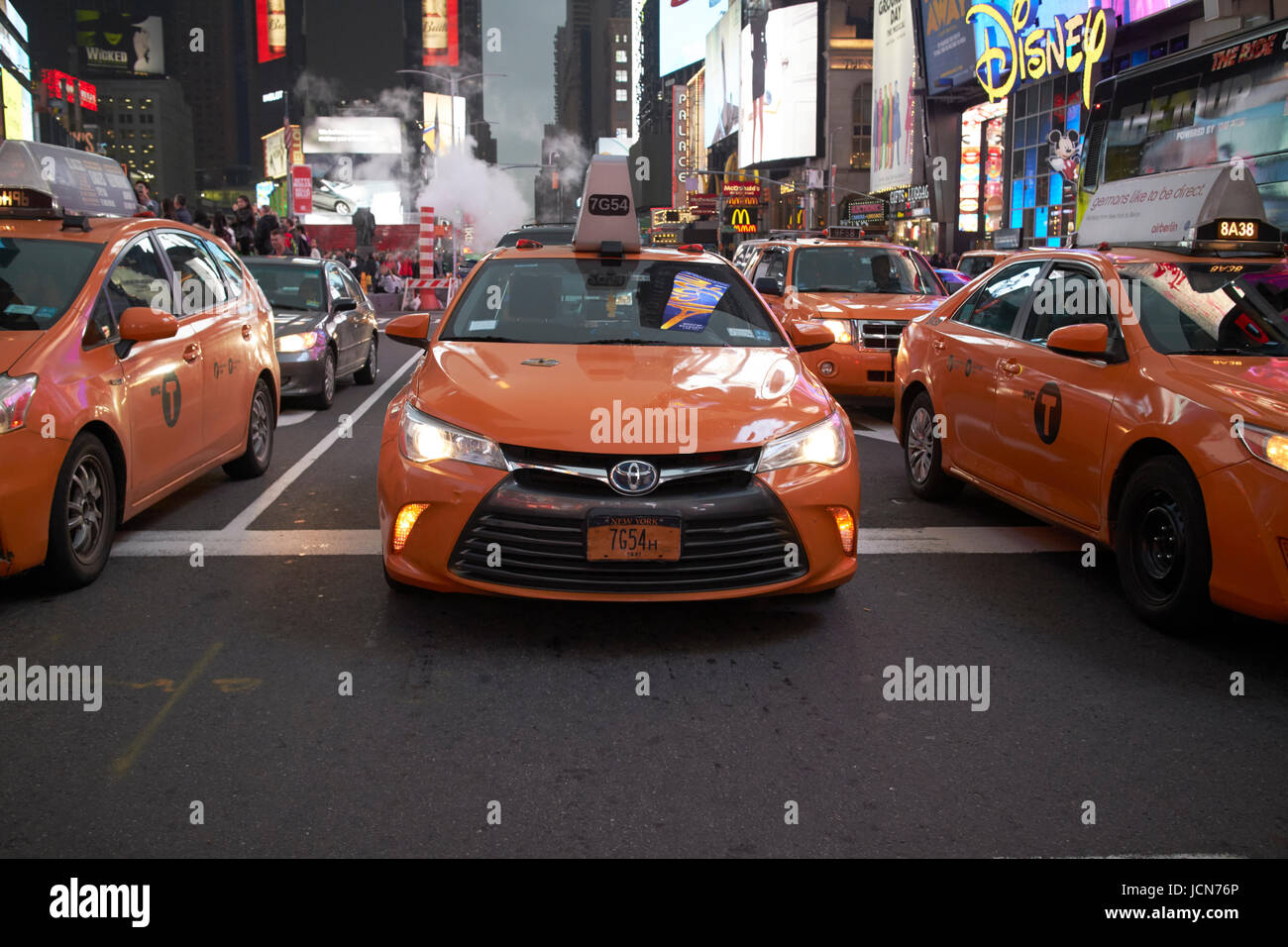 yellow cabs in the evening in Times Square New York City USA Stock Photo
