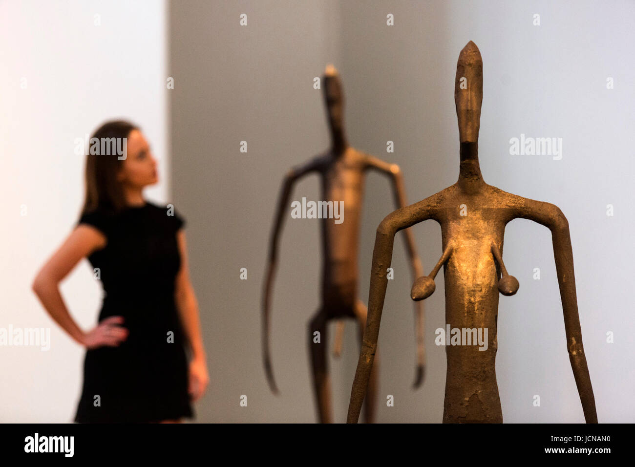 London, UK. 16 June 2017. A Christie's employee looks at the Antony Gromley sculptures Inside Australia Prototype Simon Jones and Tamara Jenks, estimate GBP 120,000-180,000 each. Auction house Christie's presents a preview of the Modern British and Irish Art sale on 26 June 2017. Stock Photo