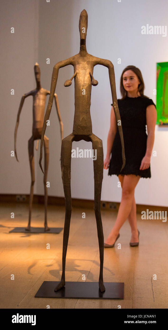 London, UK. 16 June 2017. A Christie's employee looks at the Antony Gromley sculptures Inside Australia Prototype Simon Jones and Tamara Jenks, estimate GBP 120,000-180,000 each. Auction house Christie's presents a preview of the Modern British and Irish Art sale on 26 June 2017. Stock Photo