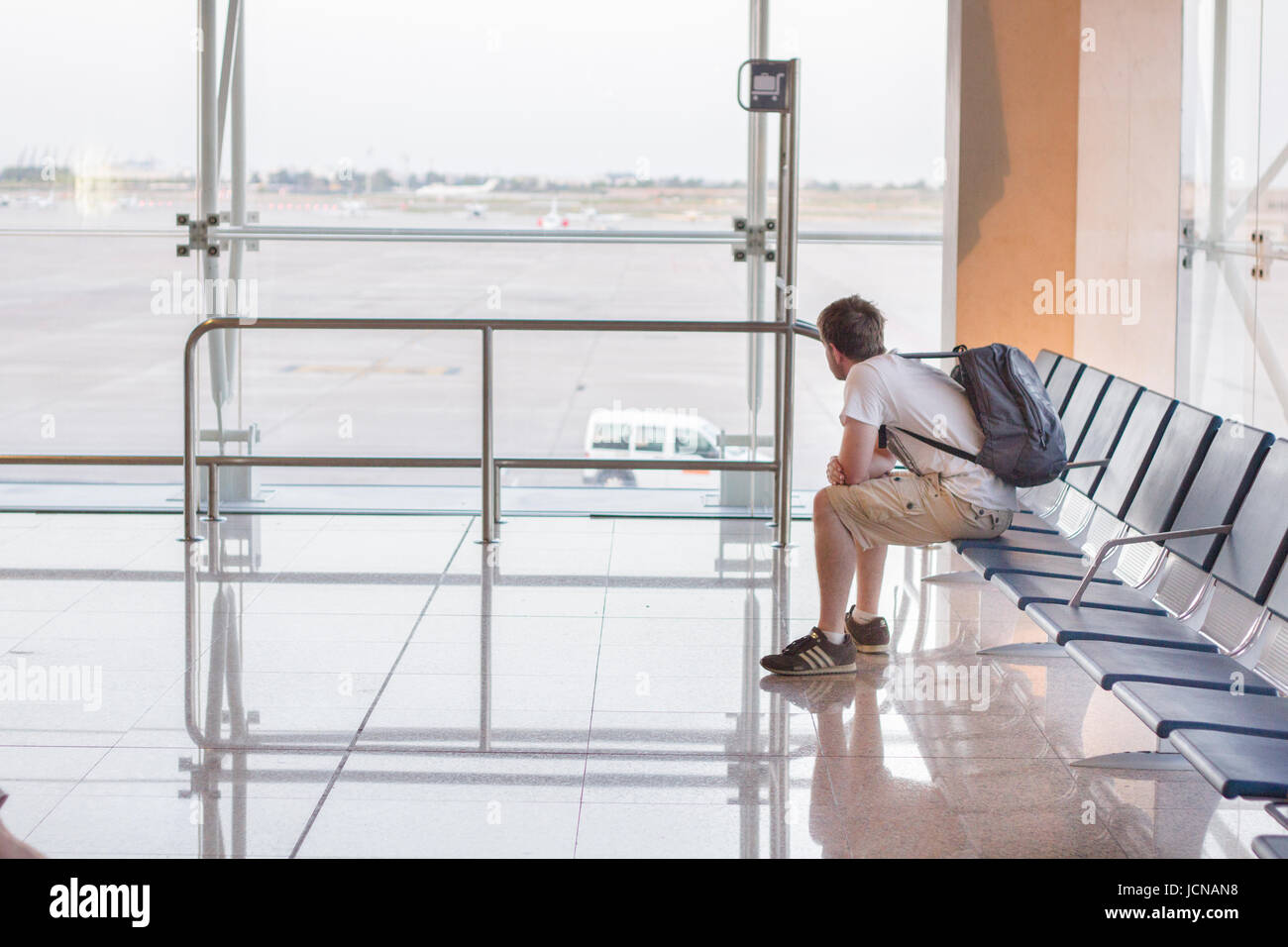 Young man waits in airport Stock Photo