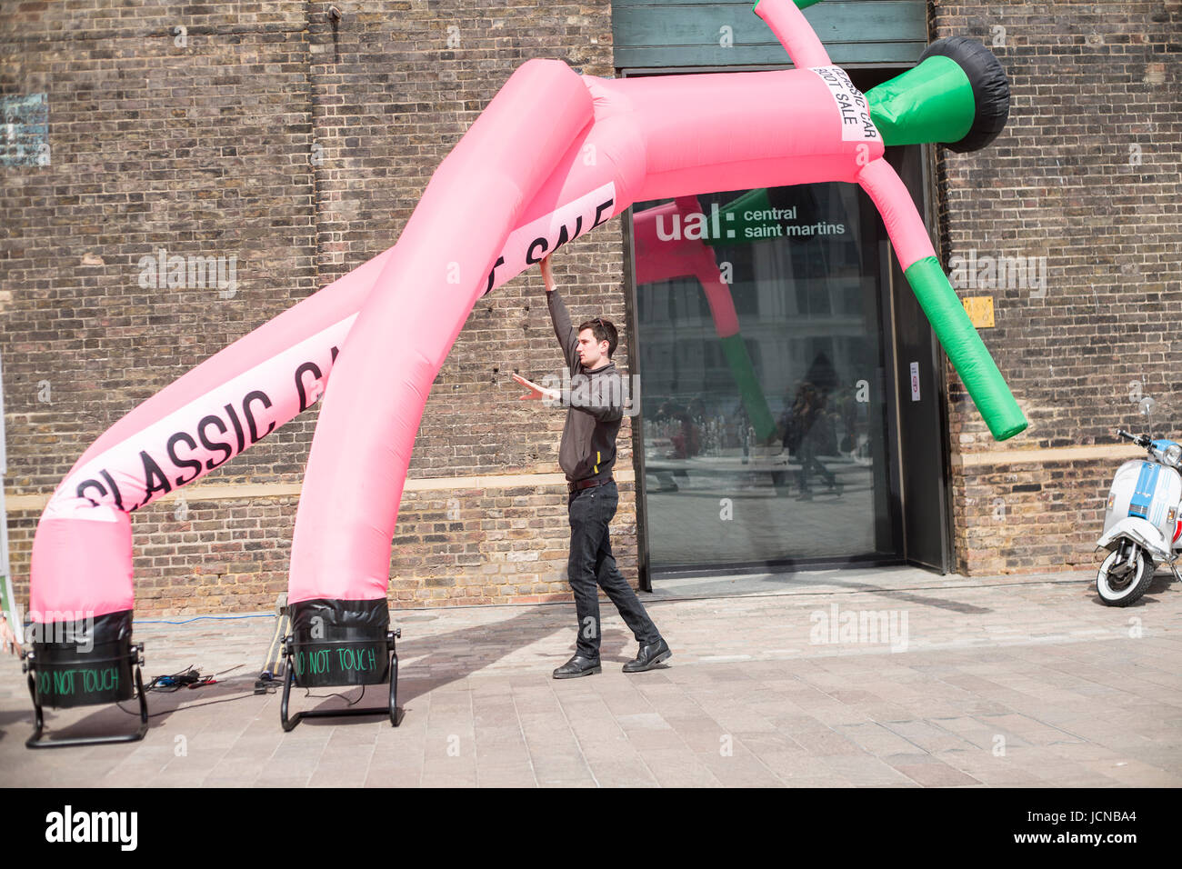 Man puts up inflatable at event Stock Photo