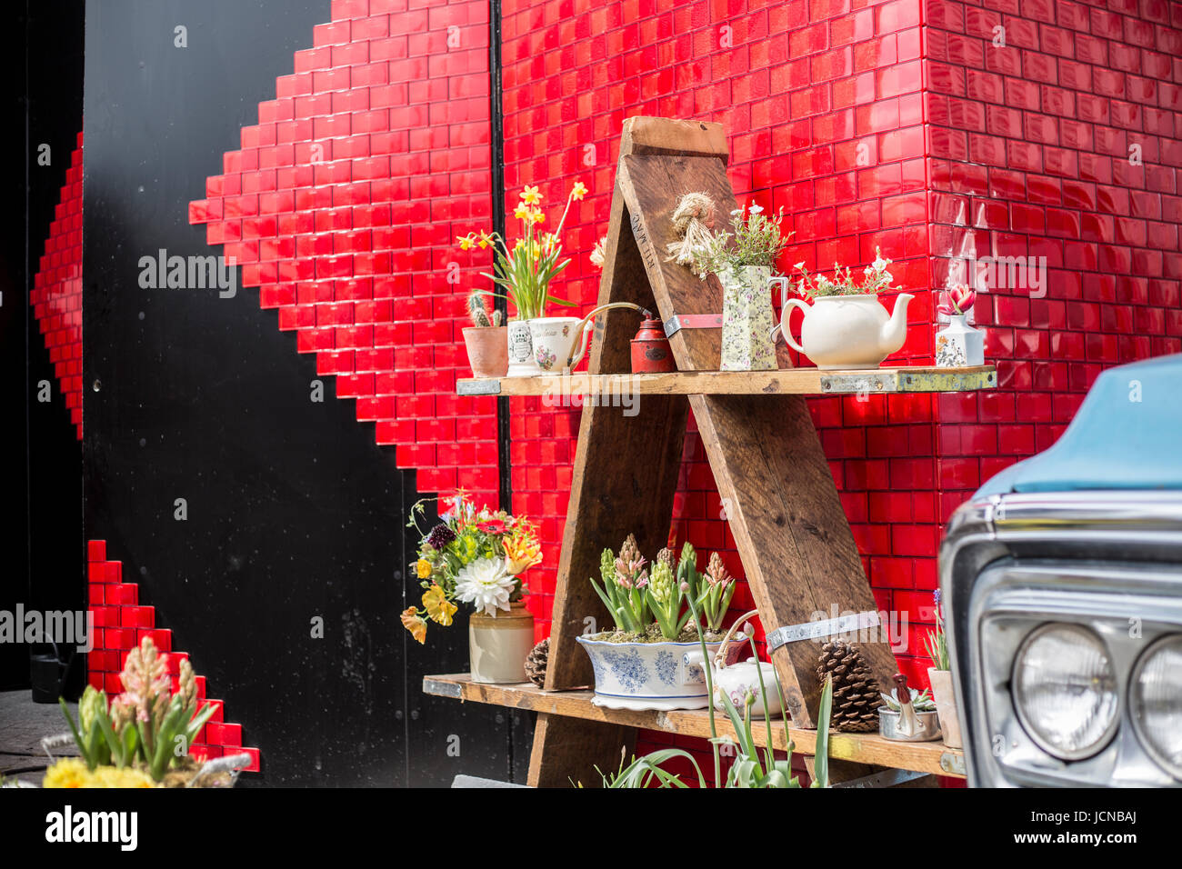 Red wall at vintage market, London. Stock Photo