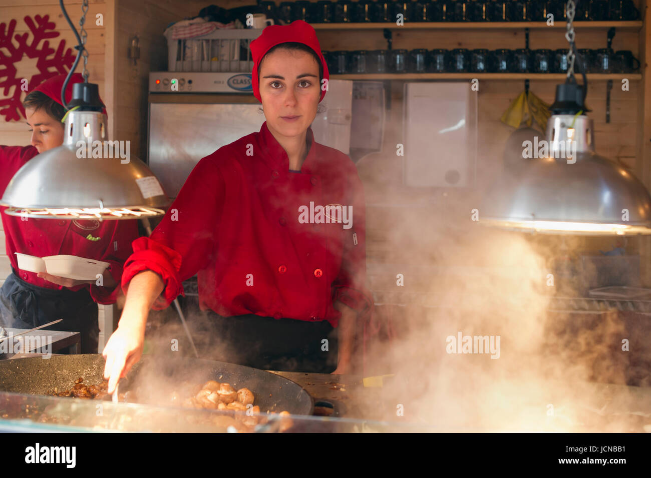 Lady cooks food at Manchester Christmas market. Stock Photo