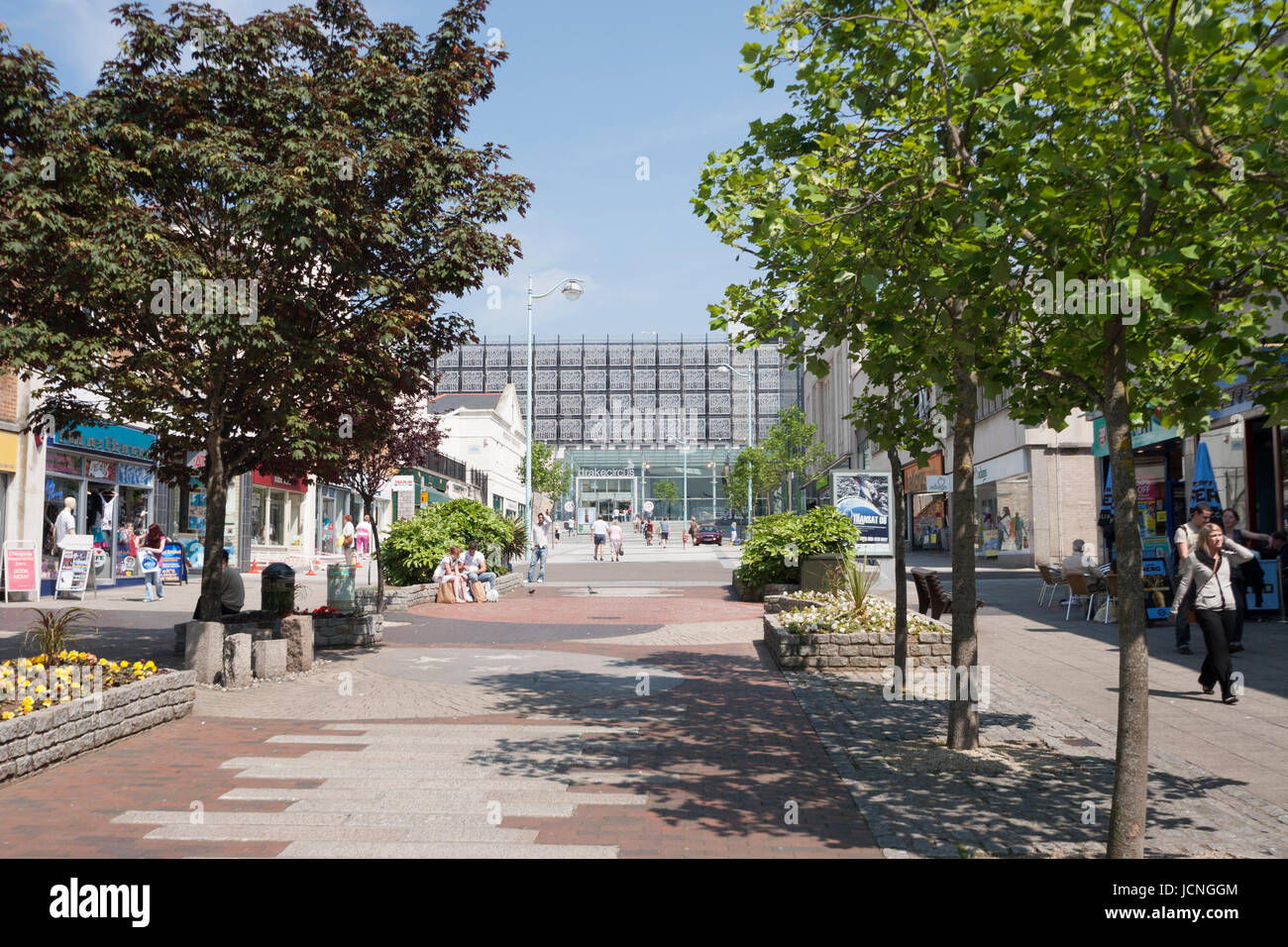 Exterior of Drake's Circus shopping centre in Plymouth with tree lined walkway, path to shops on sunny summer day. Devon, UK, United Kingdom Stock Photo