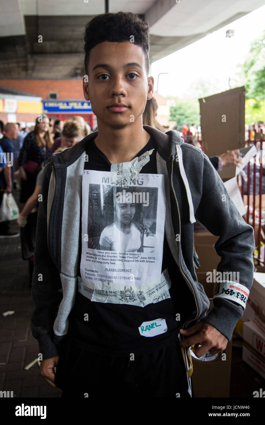London, UK. 16th June, 2017. A teenager has stuck a missing person's leaflet to his T-shirt. The Notting Hill community mourns the victims and comes together to help those who lost everything after the Grenfell Tower fire on Wednesday. Credit: Bettina Strenske/Alamy Live News Stock Photo