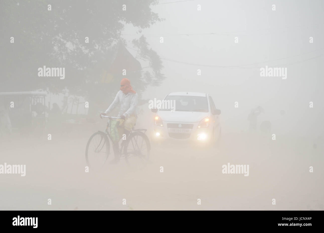 Allahabad, Uttar Pradesh, India. 16th June, 2017. People walk through a dust storm at the Sangam, the confluence of the Ganges, Yamuna and mythical Saraswati rivers in Allahabad. Credit: Prabhat Kumar Verma/ZUMA Wire/Alamy Live News Stock Photo