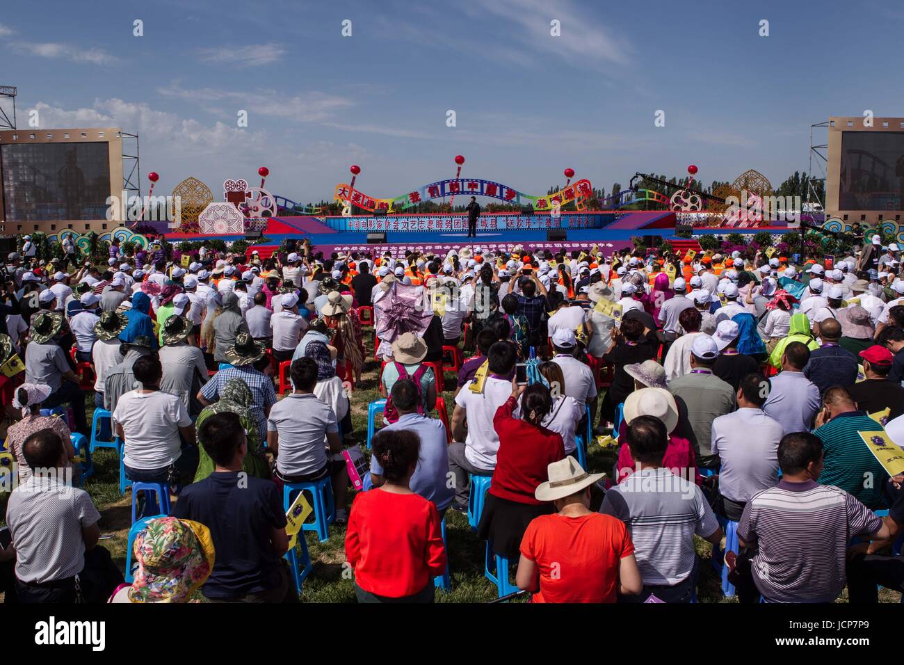 Huocheng, China's Xinjiang Uygur Autonomous Region. 17th June, 2017. Spectators watch a performance at an opening ceremony for a tourism festival in a lavender plantation in Huocheng County in Ili Kazakh Autonomous Prefecture, northwest China's Xinjiang Uygur Autonomous Region, June 17, 2017. The 7th international lavender tourism festival started in Huocheng County on Saturday. Credit: Cen Yunpeng/Xinhua/Alamy Live News Stock Photo