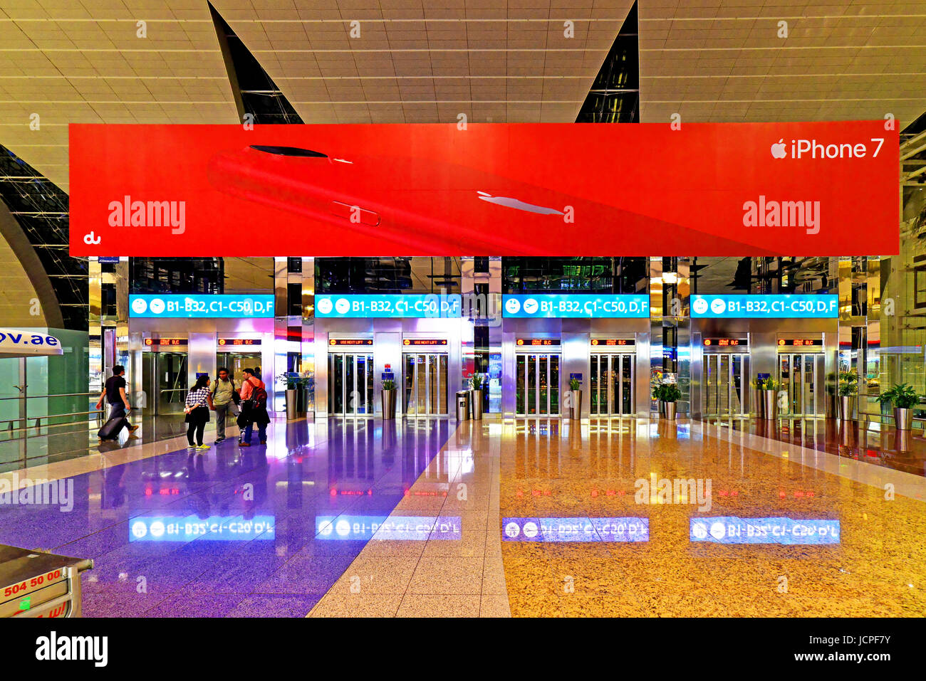 Dubai International Airport departure gates and IPhone 7 advert Stock Photo
