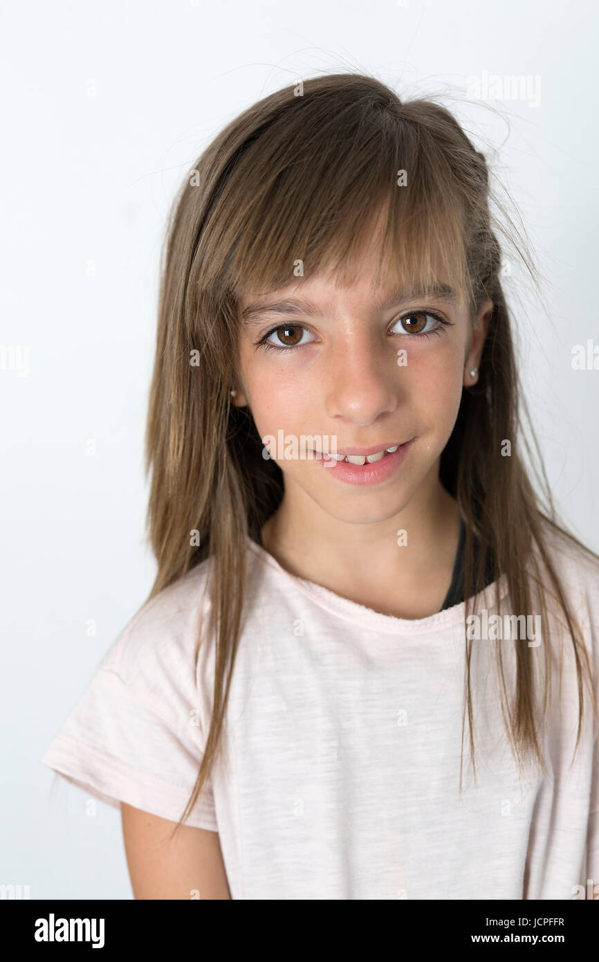 Portrait Of 10 Year Old Girl With Serious Face On A White