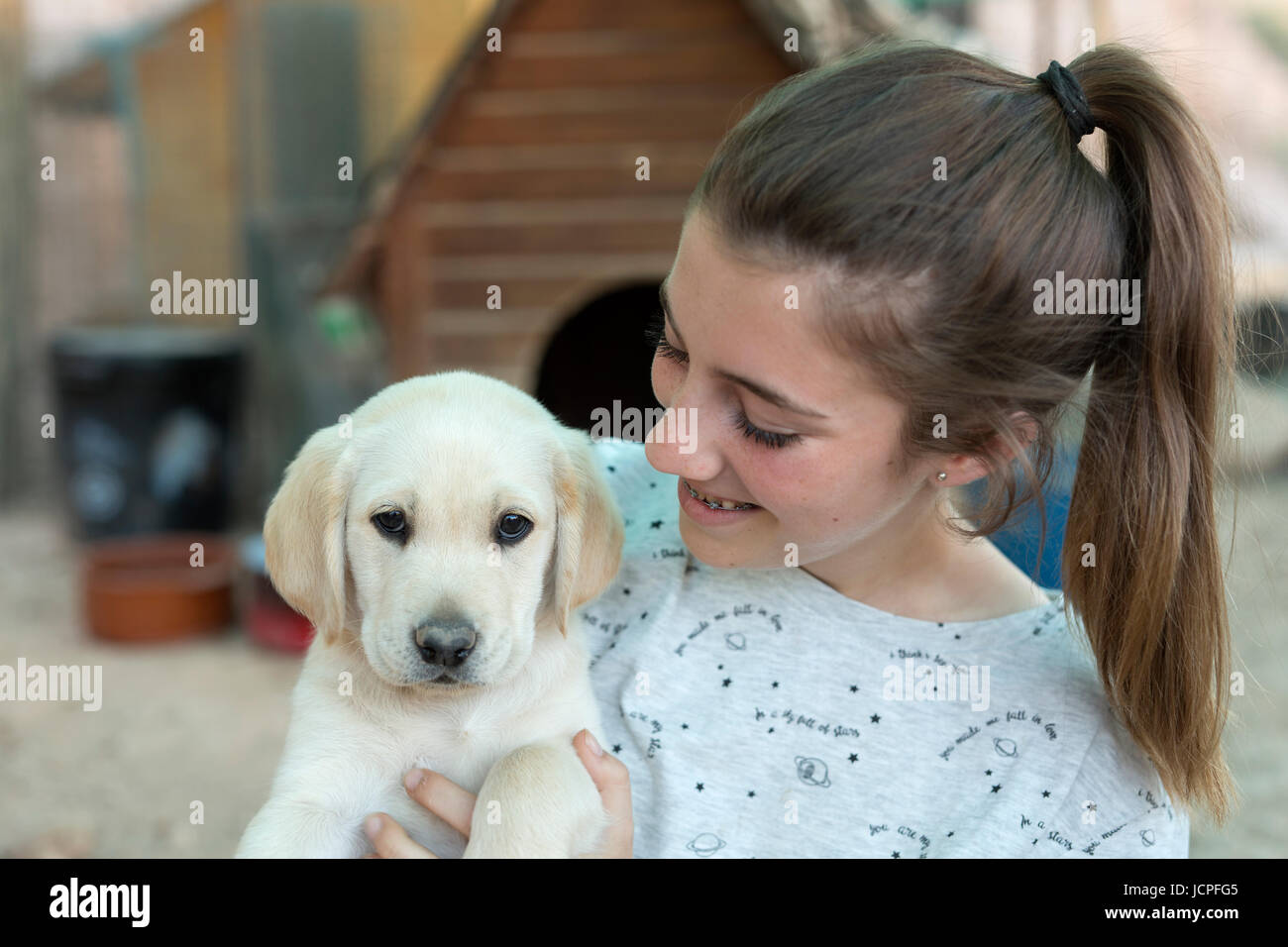 Portrait of a teenage girl with a golden retriever puppy Stock Photo ...