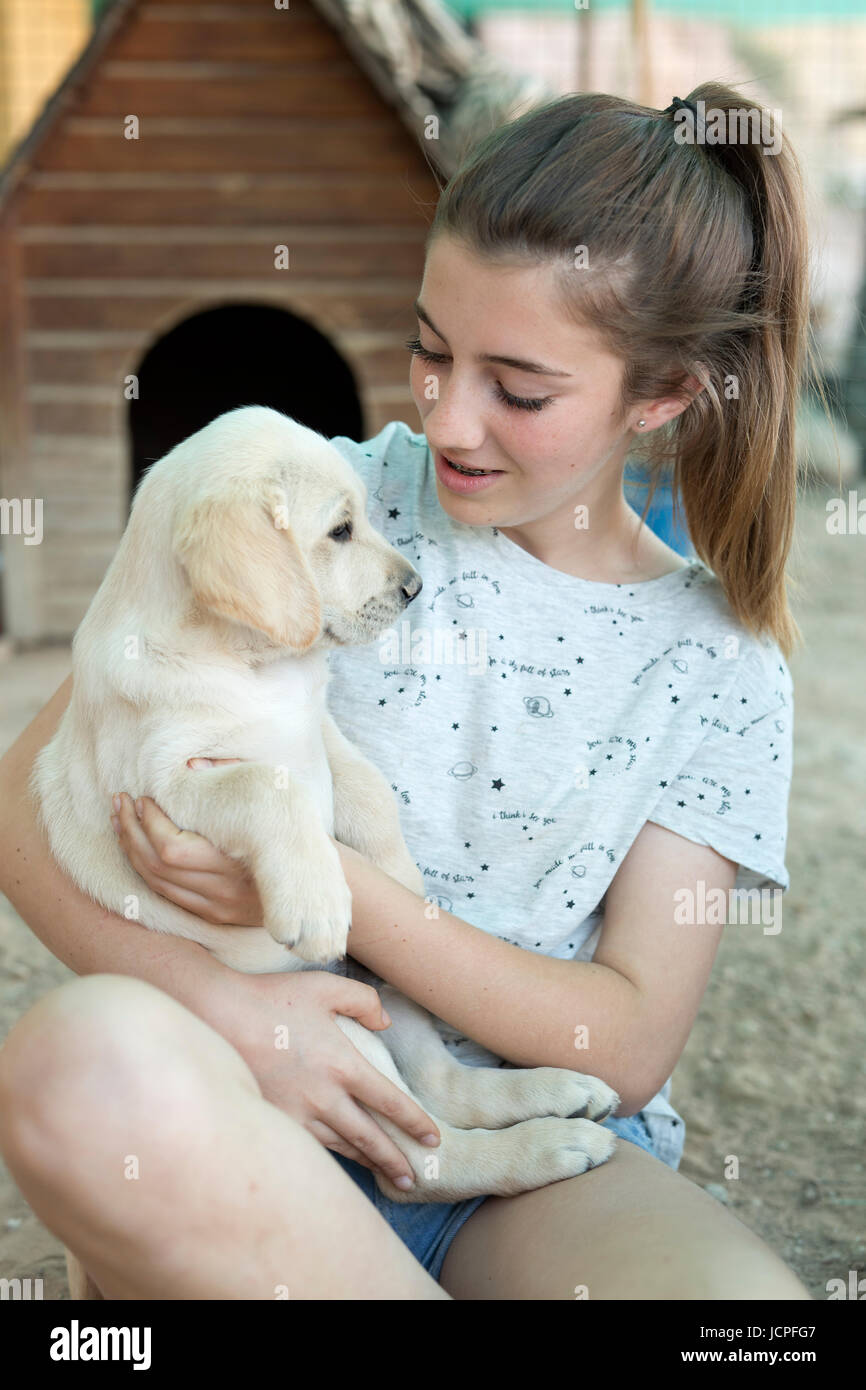 Portrait of a teenage girl with a golden retriever puppy Stock Photo ...