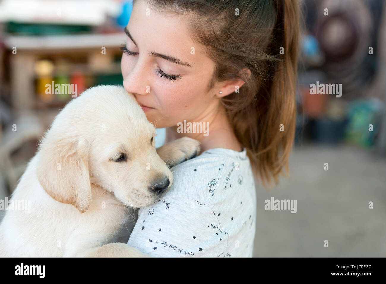 Portrait of a teenage girl with a golden retriever puppy Stock Photo ...