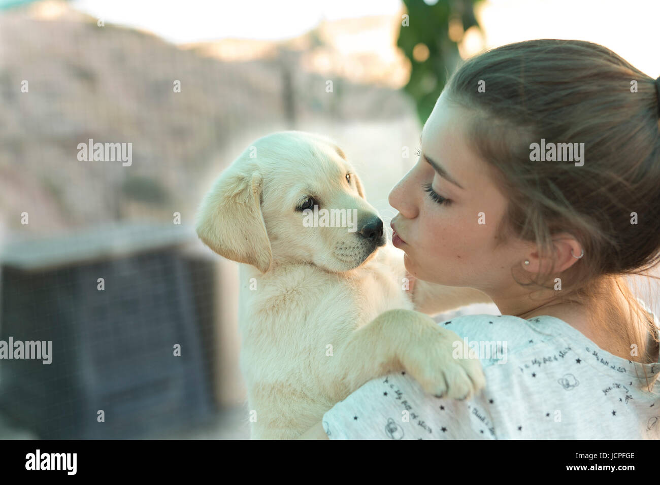 Portrait of a teenage girl with a golden retriever puppy Stock Photo ...