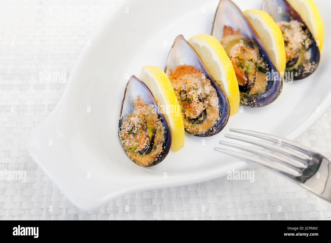 Grilled mussels cooked in the oven, by slices of lemon