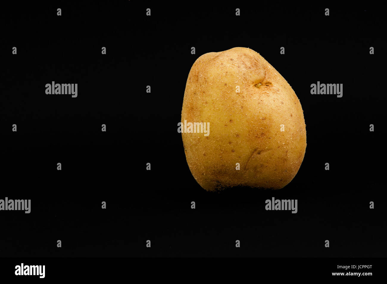 Potato on black. Stock Photo