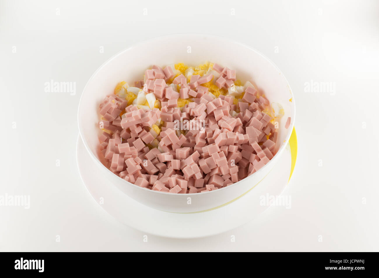 Cut sausage with egg is a preparation for meat salad Stock Photo
