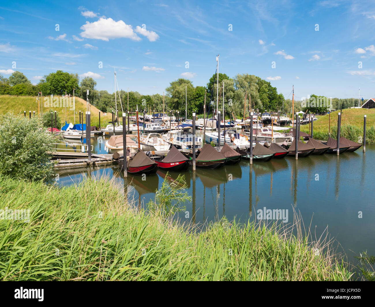 Traditional and pleasure boats in marina of fortified town of Woudrichem, Brabant, Netherlands Stock Photo