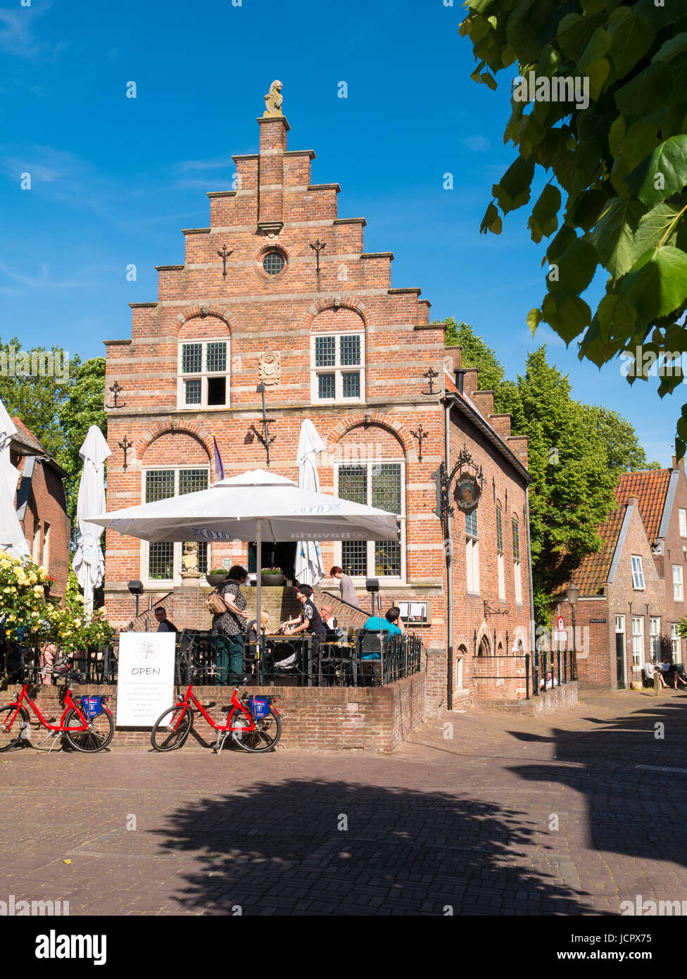 People enjoying on outdoor terrace of cafe in old town hall in centre of fortified city of Woudrichem, Brabant, Netherlands Stock Photo