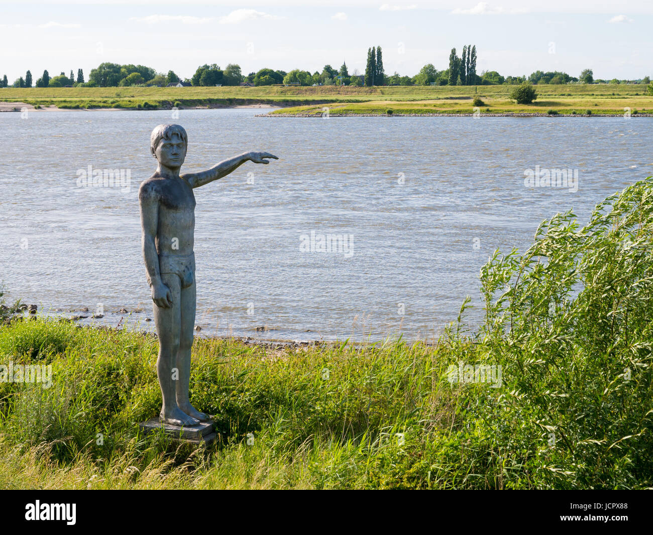 Statue of waterboy on south bank of Waal river near Waalkade in fortified town of Zaltbommel, Gelderland, Netherlands Stock Photo