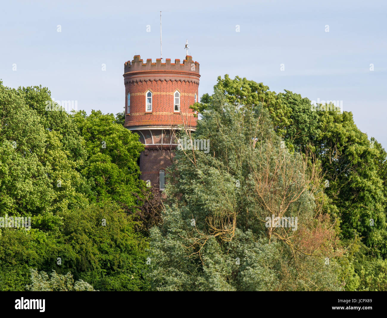Old water tower hidden in trees in fortified town of Zaltbommel, Gelderland, Netherlands Stock Photo