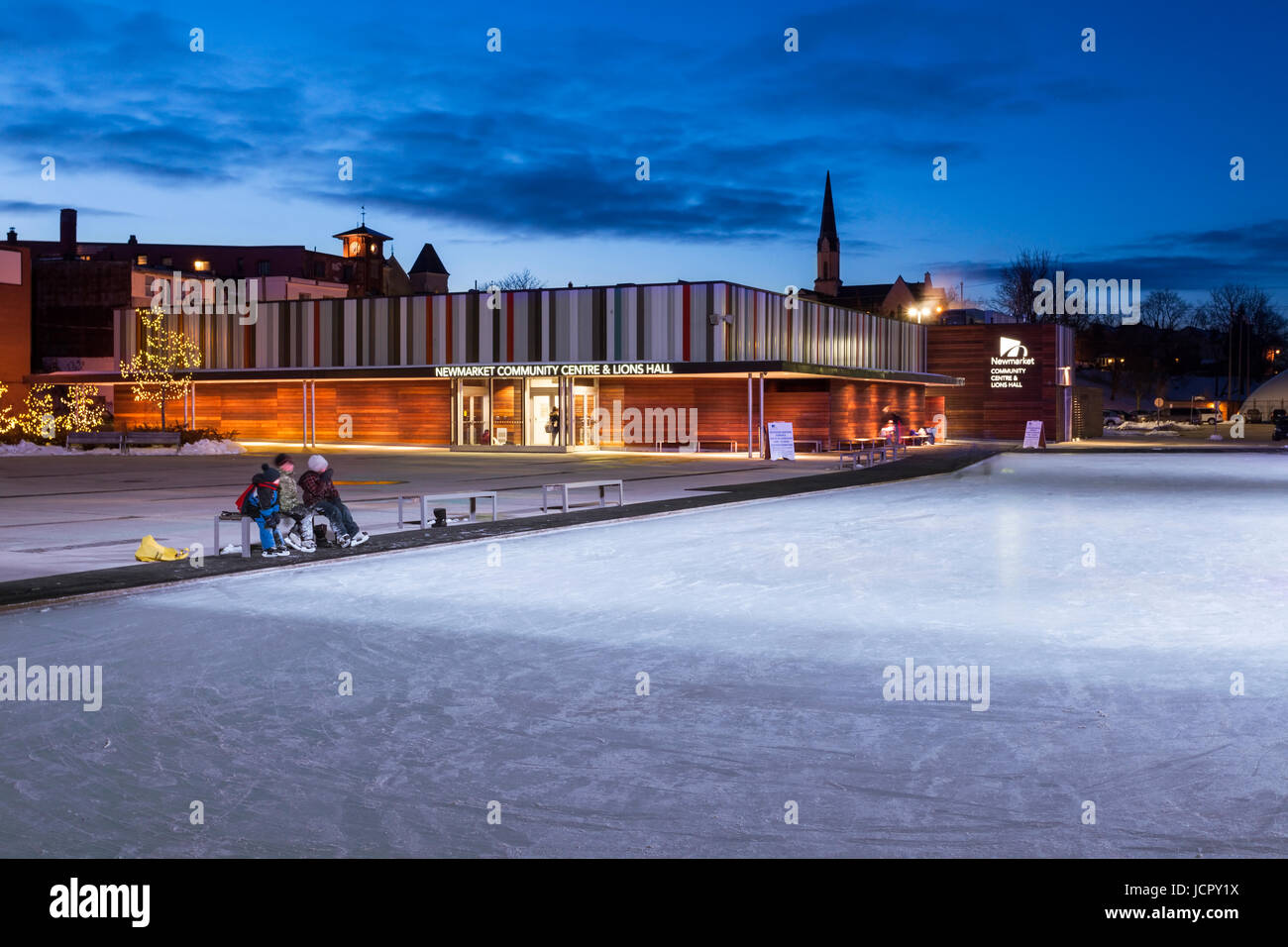 The Newmarket Community Centre in the winter with people, ice skaters in downtown Newmarket, York Region, Ontario, Canada. Stock Photo