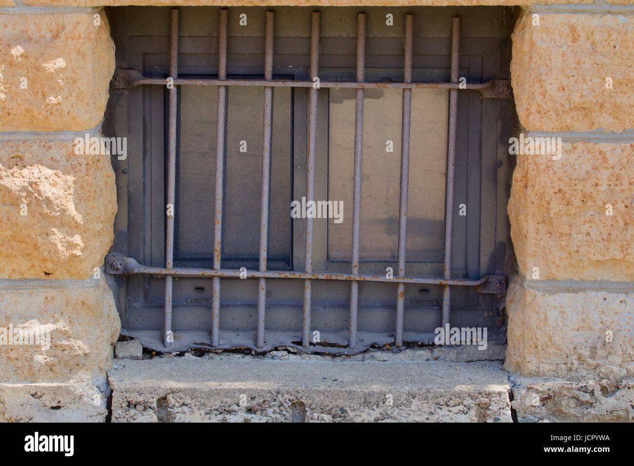 Bar covered window in stone builiding Stock Photo