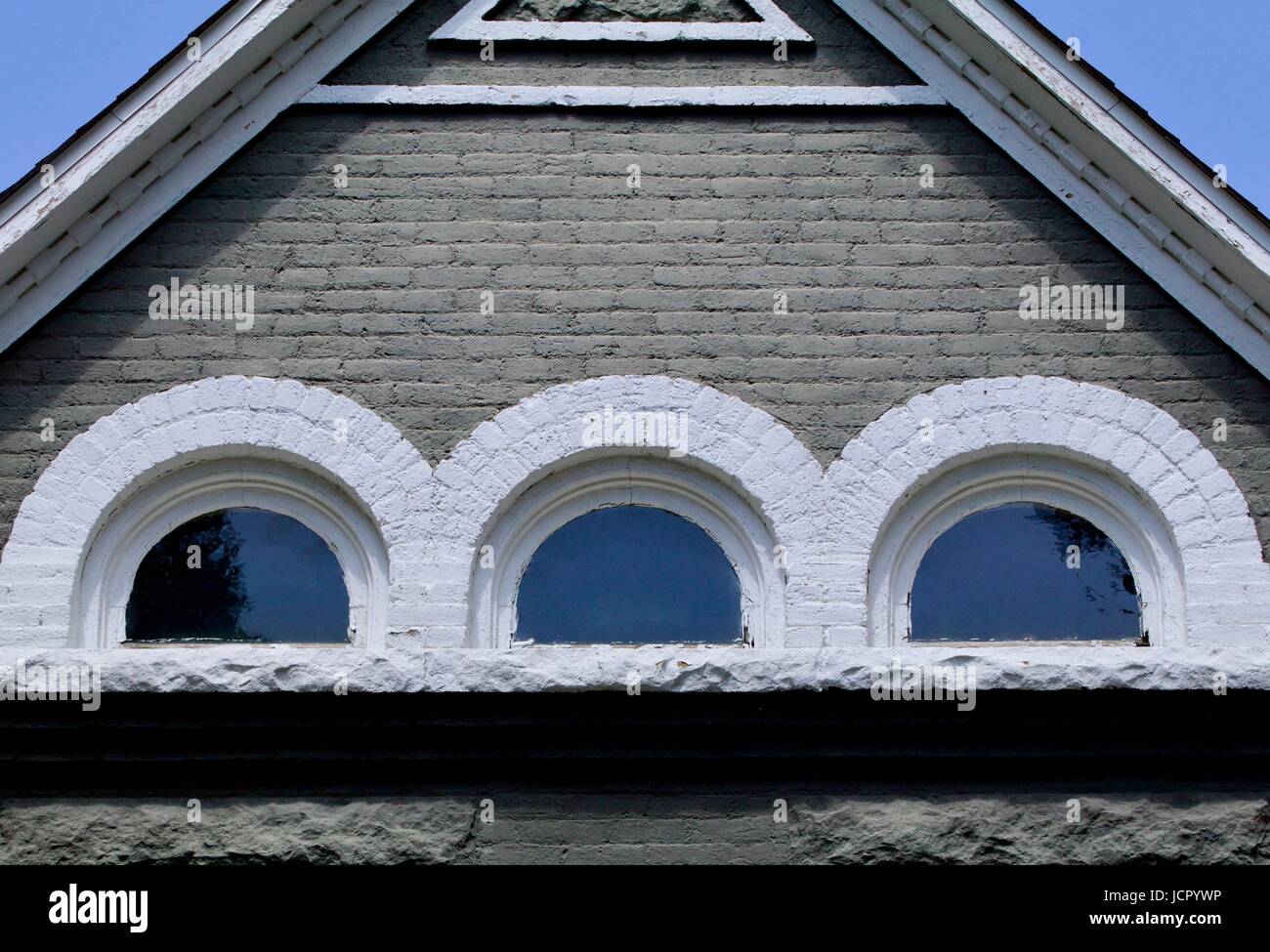 Old brick house attic windows Stock Photo