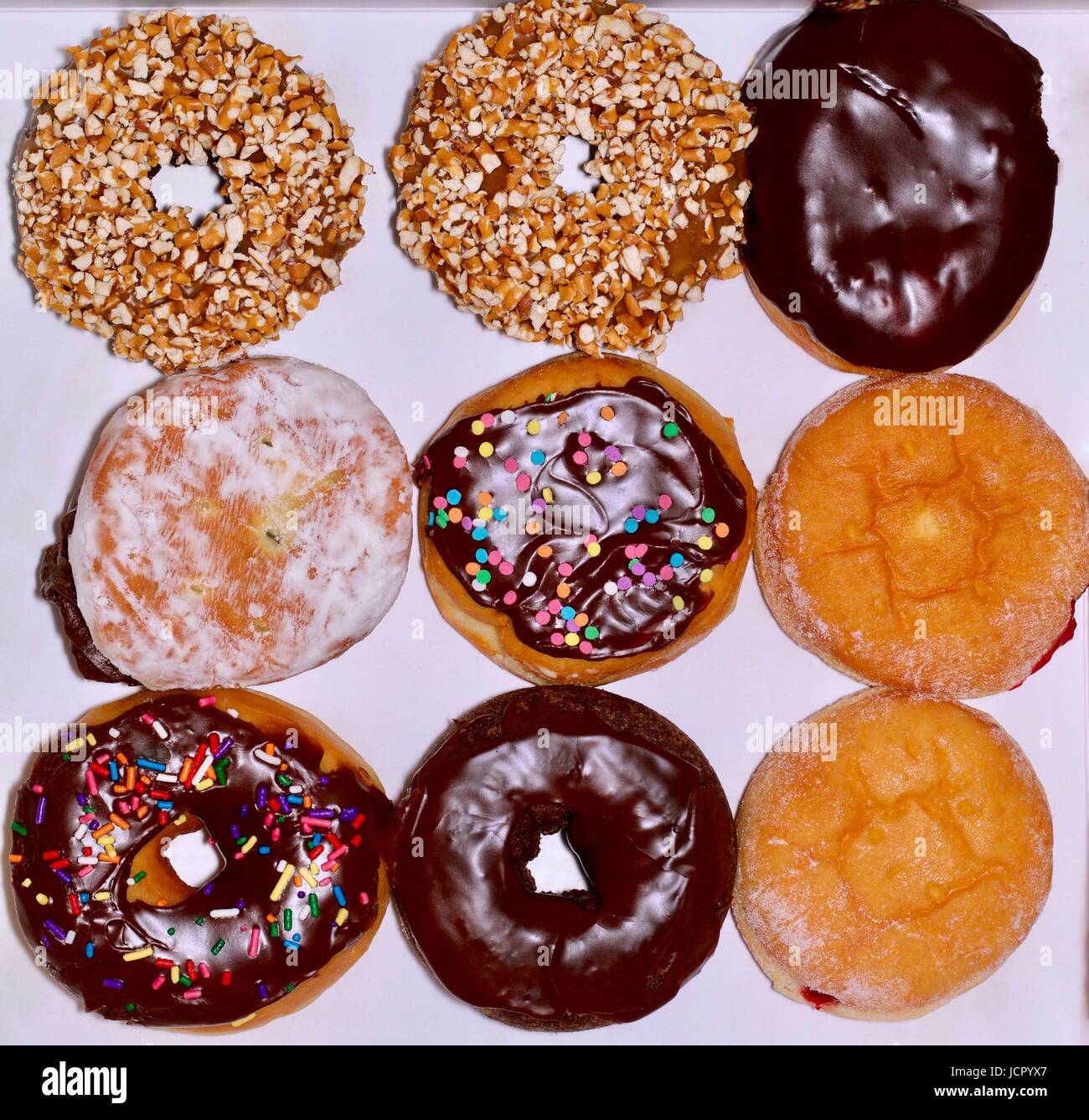 Nine fancy doughnuts on a white background Stock Photo