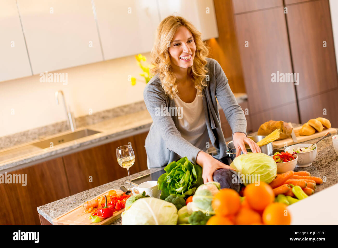 Young woman preparing food in modern kitchen Stock Photo