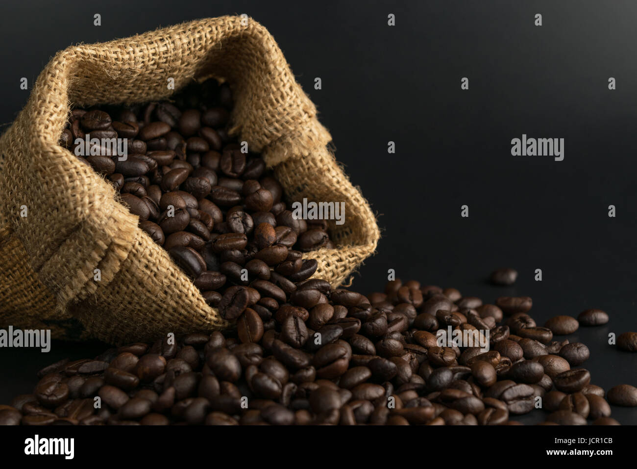 coffee beans in sack on black background Stock Photo - Alamy