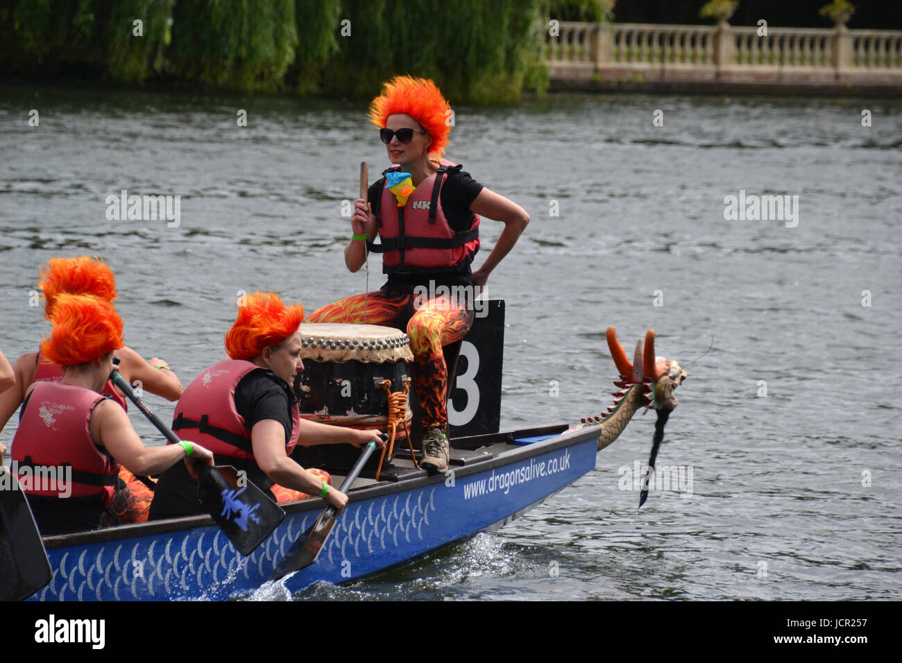 Team with firey orange hair at the Marlow dragon boat races on the River Thames, Marlow, Buckinghamshire, England, UK Stock Photo