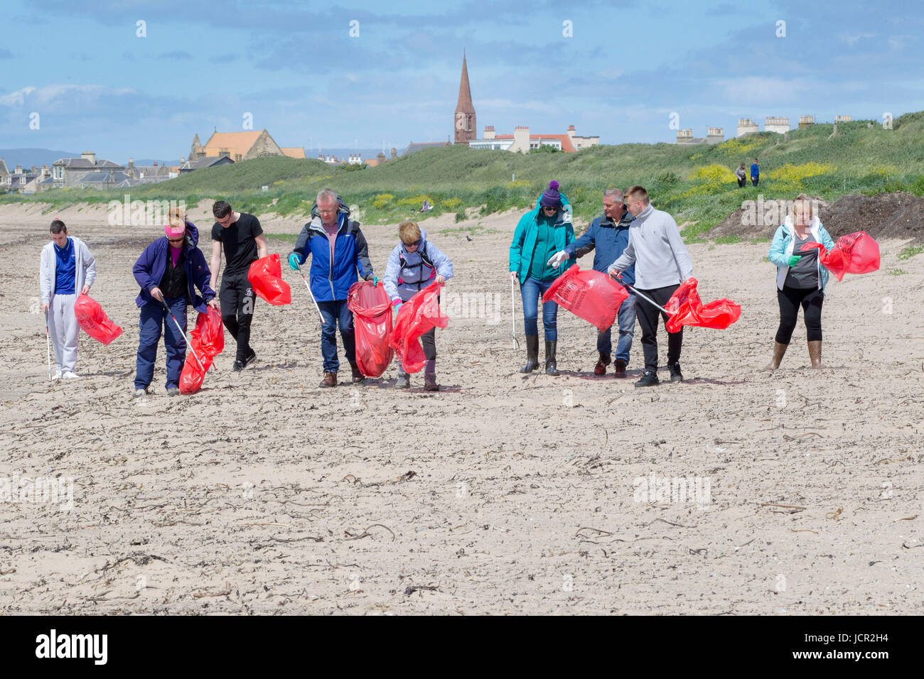 Volunteers picking up litter on Troon Beach Scotland Stock Photo Alamy